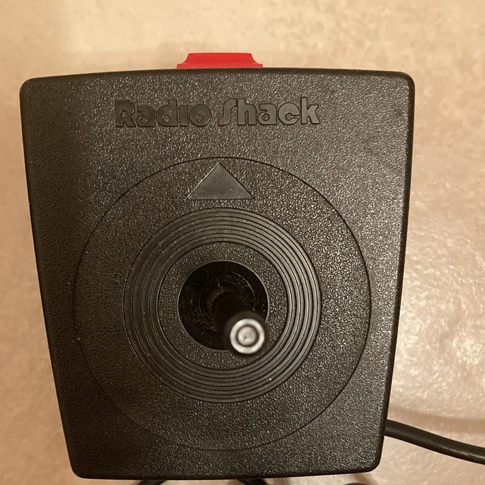 Radio Shack TRS-80 joysticks, game cable, game cartridge and Color Basic manual